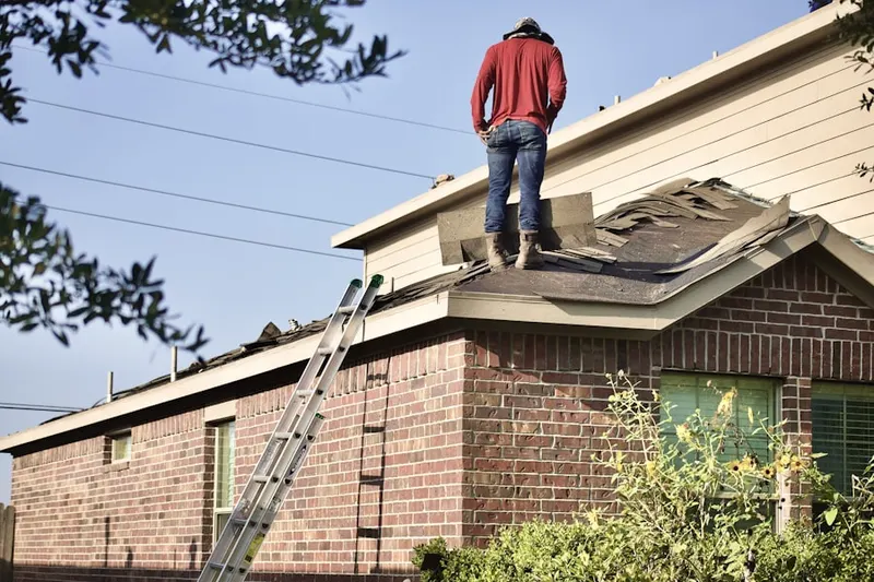 Professional roofer working on a residential roof in Davis Corner